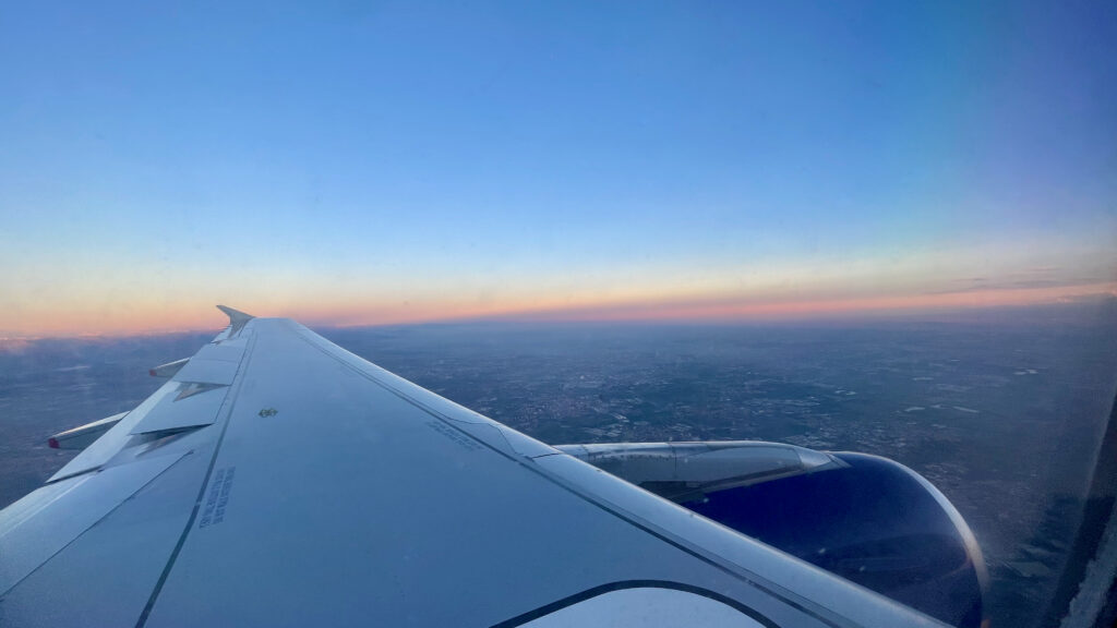 Airplane Wing with a sunset in the background.