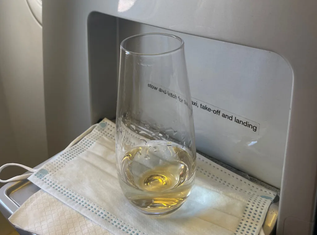 Glass of Champagne in Air New Zealand Business Premier Seat Shelf
